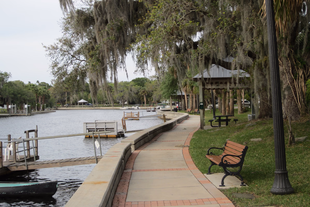 Riverfront walkway, docks, and live oaks at Cotee River Park in New Port Richey